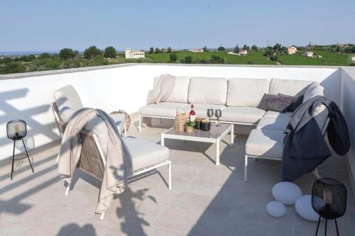 a patio with a couch and chairs on a roof at Charming Boutique B&B Hotel in Villalfonsina
