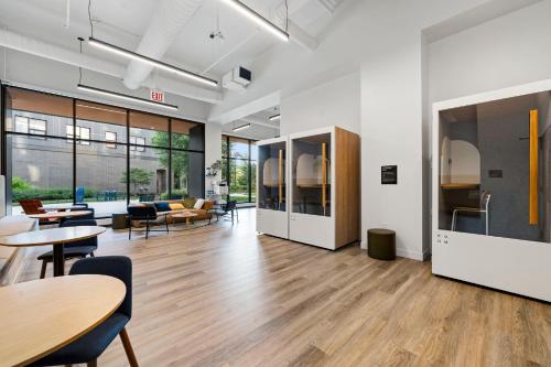 an open office with tables and chairs and tablespaces at 2BR City Escape Bright Sleek Spacious in Chicago