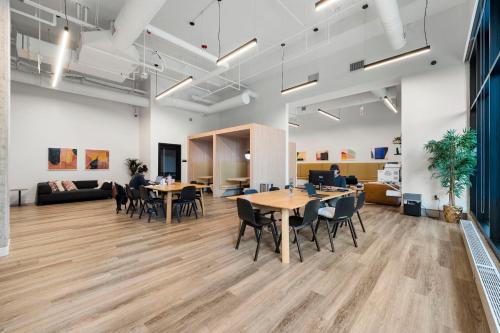 an office with tables and chairs and a couch at 2BR City Escape Bright Sleek Spacious in Chicago