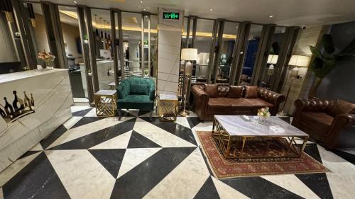 a lobby with couches and chairs in a building at TAJ Executive Hotel F7 Islamabad in Islamabad