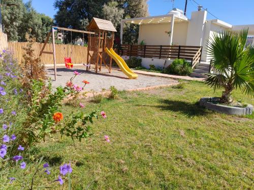 a yard with a playground with a slide at Sandy Ridge in Kalamaki Heraklion