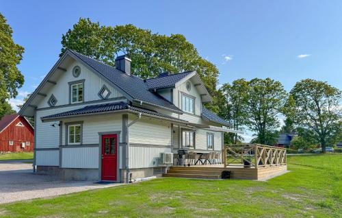 a large white house with a red door at Pet Friendly Home In Bolmsö With Sauna in Bolmsö