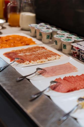 a buffet with several different types of food on a table at Hotel De Zes Bochten in Knokke-Heist