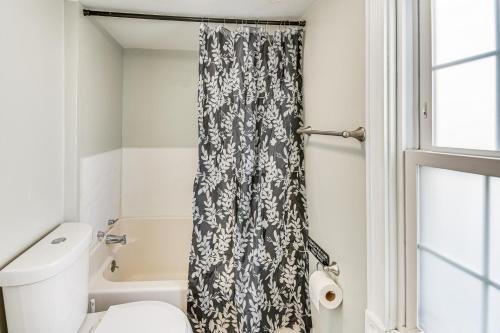 a bathroom with a black and white shower curtain at Spacious Family Home with Yard in Dtwn Hampton! in Hampton