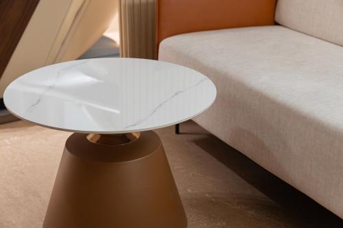 a white table sitting next to a bed at Browndot Incheon Airport New City in Incheon