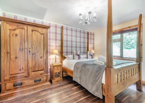a bedroom with a bed and a window at Charlesworth Lodges in Glossop