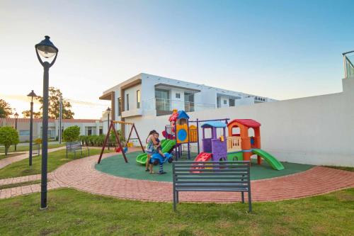 a park with a playground with a bench at Viru Viru Express PrecioCalidad in Santa Cruz de la Sierra