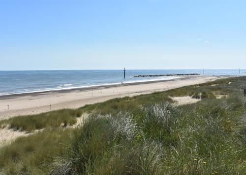 an empty beach with the ocean in the background at Anchor Park in Happisburgh