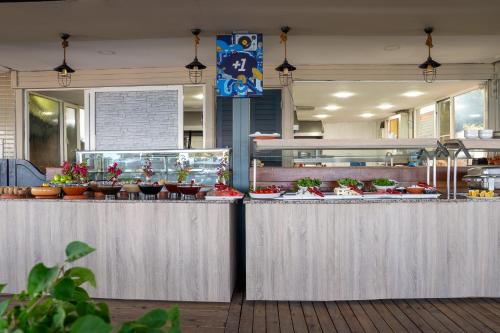 a restaurant with a counter with food on it at Side Beach Club in Side