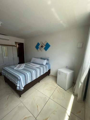 a bedroom with a bed in a room at Suite Pajuçara in Maceió