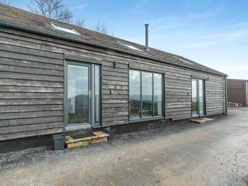 a house with windows on the side of it at Kinder in Mellor