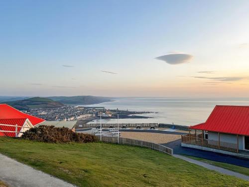 a view of a harbor with a red roof at Cliff Railway Apartment in Aberystwyth