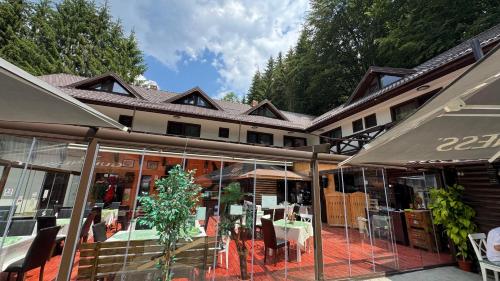 a restaurant with tables and chairs in front of a building at Conacul Dascălu in Trăisteni