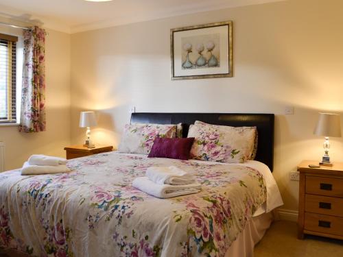 a bedroom with a bed with towels on it at Ty Glyndwr in Ystalyfera