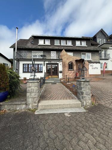 a large house with a brick driveway in front of it at Haus Sonnenschein in Winterberg