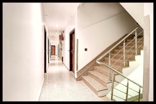 a hallway with stairs in a house at HOTEL C-D-P NARAYANA - Peaceful & Comfortable Stay Near Kashi Vishwanath Temple in Varanasi