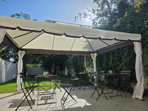 a large tent with chairs and tables in a yard at Le 46 Appart Hotel Entre Paris Disneyland Parc Asterix Navette in Villiers-sur-Marne