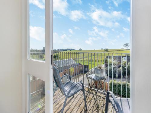 a room with a balcony with a chair and a window at Walker's Retreat - Uk45415 in Eaton Bishop
