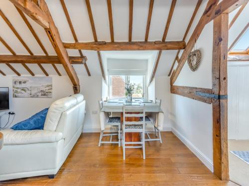 a living room with a white couch and a table at Walker's Retreat - Uk45415 in Eaton Bishop
