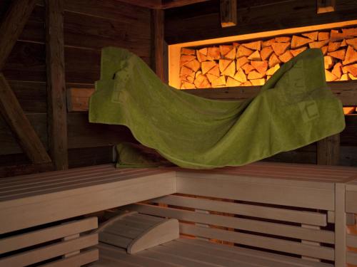 a sauna with a green sheet on the roof at Natürlich Hotel mit Charakter in Fiss