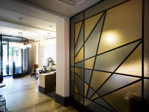 a living room with a sliding glass door at Hôtel Mercure Rodez Cathédrale in Rodez