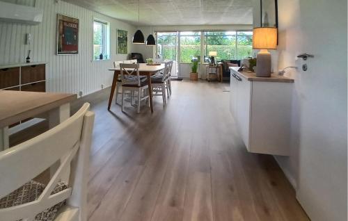 a kitchen and dining room with a hard wood floor at Nice Home In Tarm With Kitchen in Hemmet