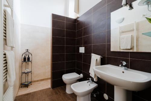 a bathroom with a white toilet and a sink at Masseria La Lizza - Ospitalità Rurale in Lecce