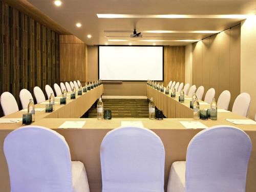 a meeting room with chairs and a projection screen at ibis Styles Krabi Ao Nang in Ao Nang Beach