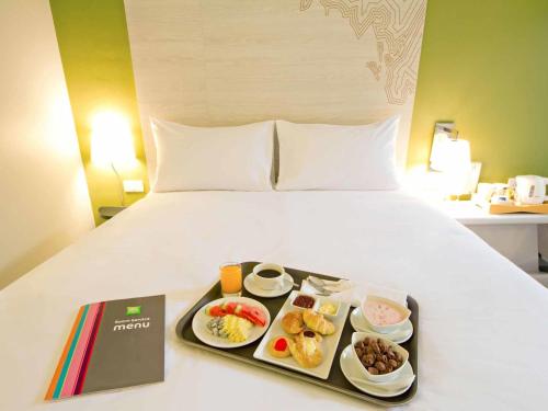 a tray of food sitting on top of a bed at ibis Styles Krabi Ao Nang in Ao Nang Beach