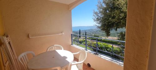 a table and chairs on a balcony with a view at Apartment with view in Roquebrune-sur-Argens in Roquebrune-sur-Argens