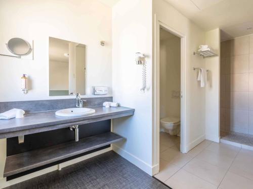 a bathroom with a sink and a toilet at Mercure Aix-En-Provence Sainte-Victoire in Châteauneuf-le-Rouge