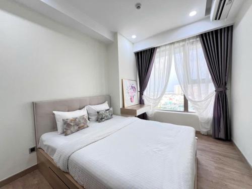 Ένα ή περισσότερα κρεβάτια σε δωμάτιο στο 2BR The Peak Midtown M8
