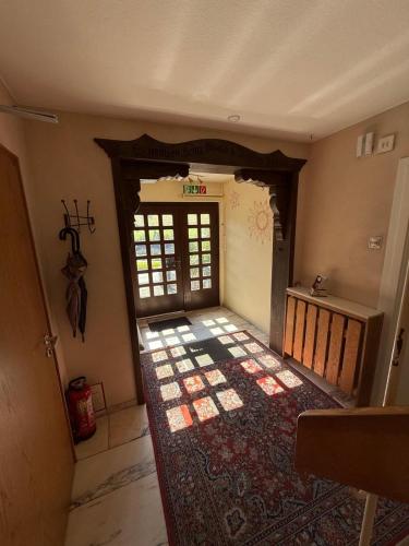 an entrance to a room with a door and a rug at Haus Sonnenschein in Winterberg