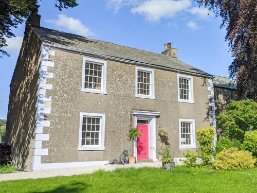 a large brick house with a red door at Fieldgate House in Bampton