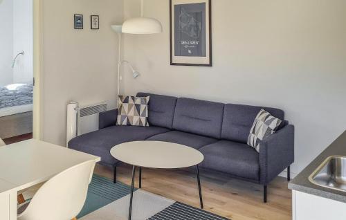 a living room with a couch and a table at Nice Apartment In Nexø With Wifi in Neksø
