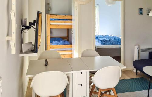 a room with a table and chairs and a bunk bed at Nice Apartment In Nexø With Wifi in Neksø