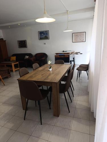 a dining room with a table and a piano at Júlia Vendégház in Sárospatak