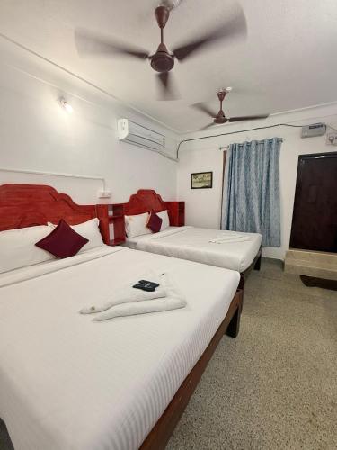 a bedroom with two beds and a ceiling at VR Jardin Resort in Pondicherry