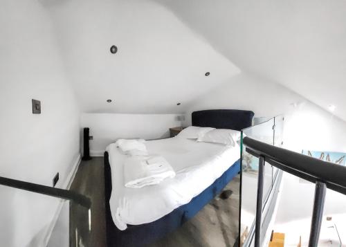 a bedroom with a bed in a white room at Bainbridge Ings in Hawes