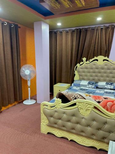 a yellow bed in a room with a fan at Mountain view Escape in Kathmandu