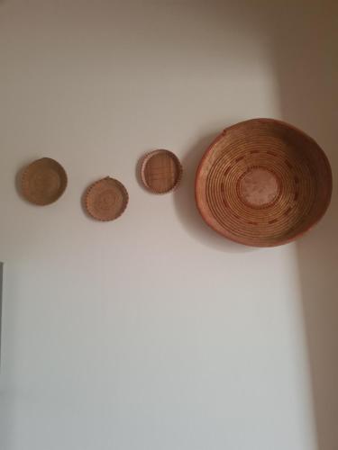 a group of five coins on a wall at Casa Antonella in Sìnnai