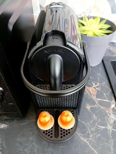a coffee maker with two eggs in it on a counter at Topaze - En plein coeur de la ville Dijon in Dijon