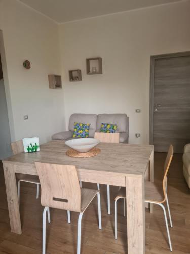 a wooden table and chairs in a living room at Casa Antonella in Sìnnai