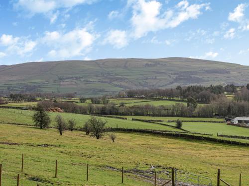 a field of green grass with hills in the background at Kinder in Mellor