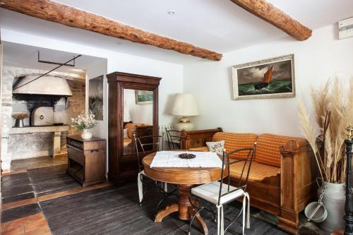 a living room with a table and a couch at Le Clos Du Buis in Bonnieux