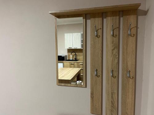 a mirror hanging on a wall in a kitchen at Apartmán na vinné stezce in Blatnice