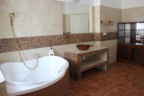 a bathroom with a large tub and a sink at ABC Homestay in Golčŭv Jeníkov