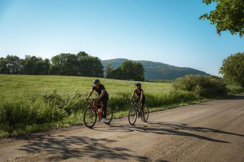 two people riding bikes down a dirt road at Hotel Chateau Bromont in Bromont