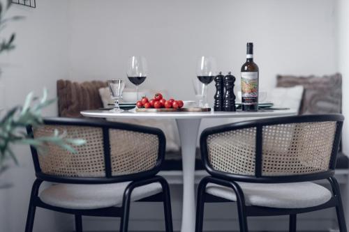 a table with two chairs and a table with wine glasses at Villa Elisabetta Lago Maggiore in Belgirate