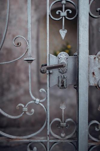 an old metal gate with a lock on it at Villa Elisabetta Lago Maggiore in Belgirate